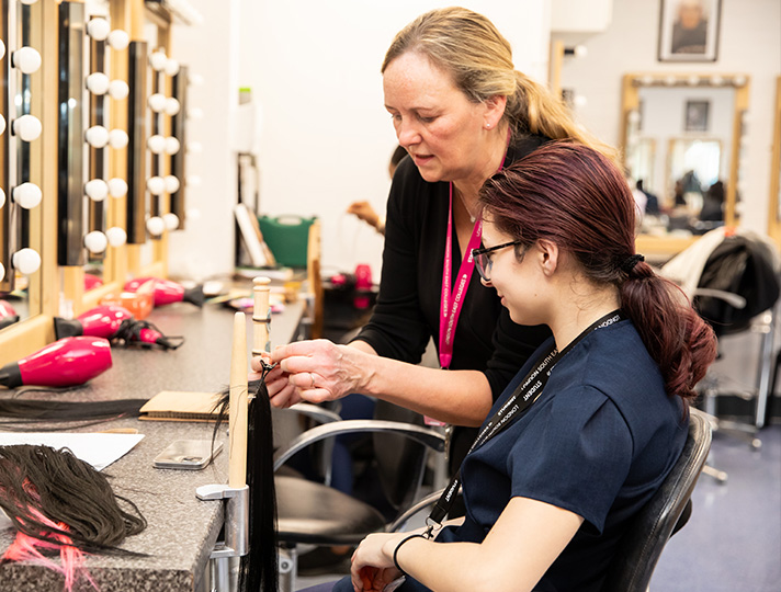 Student learning to style hair