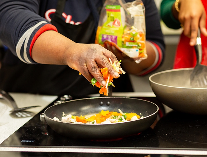 Students cooking in the living kitchen